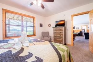 a bedroom with a bed and a dresser with a television at Starry Night Retreat By Avada Properties in Sevierville