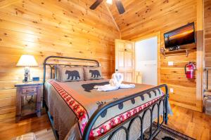 a bedroom with a bed in a log cabin at Starry Night Retreat By Avada Properties in Sevierville