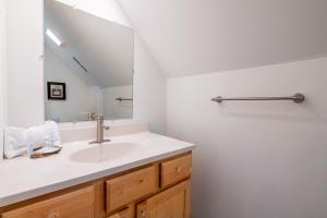 a bathroom with a sink and a mirror at Starry Night Retreat By Avada Properties in Sevierville