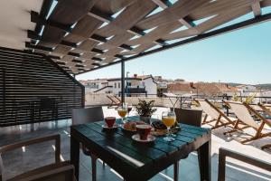 a table with glasses of wine on a balcony at Apartments Zovko in Neum