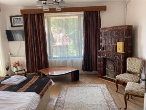 a bedroom with a bed and a window and a table at Casa Rujoiu in Bertea