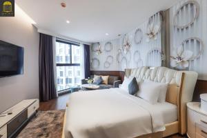 a bedroom with a large bed and a tv at Cozy Tranquility Mandala Retreat in Phan Thiet