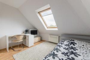 a bedroom with a bed and a desk and a window at Private Rooms in Hannover