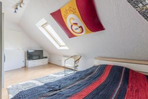 a bedroom with a large bed and a chair at Private Rooms in Hannover