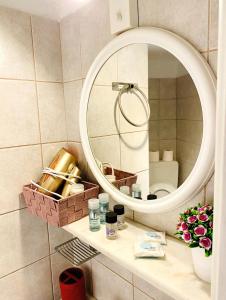 a bathroom vanity with a mirror and a sink at Chora Suite in Mikonos