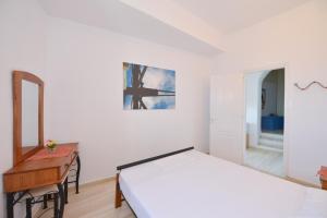 Postel nebo postele na pokoji v ubytování Windmill Villas
