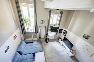 an overhead view of a living room with blue furniture at « Le Vieux Lyon » 45 m2 tt équipé Clim in Lyon