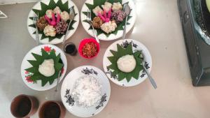 a table with plates of food and bowls of rice at P'Moon Open Inn 2 in Karangasem