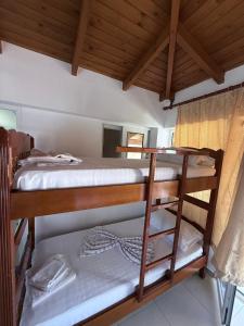 two bunk beds in a room with wooden ceilings at Denaj House in Himare