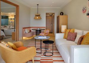 a living room with a white couch and a table at The Westin Resort, Costa Navarino in Romanu