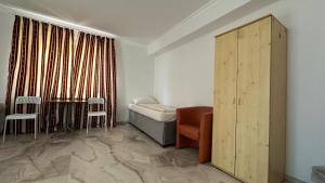 a hospital room with a bed and a table and chairs at Pension Smart Living Suites in Nuremberg