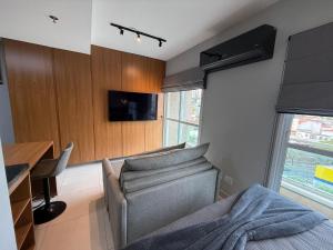 Μια τηλεόραση ή/και κέντρο ψυχαγωγίας στο Apartamento 75 - Aconchegante