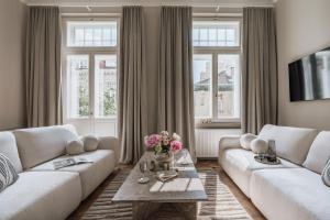 a living room with two white couches and a table at La Belle Epoque in Warsaw
