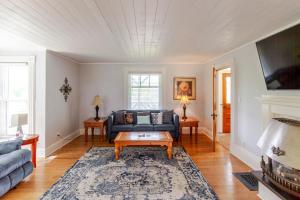 a living room with a couch and a table at Westlake Cottages - Highway House in Wellington