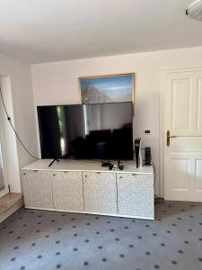 a living room with a large flat screen tv at Božič Residence in Vipava