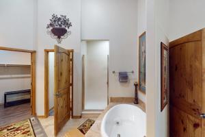 a bathroom with a large white tub in a room at Torreon Tranquility in Show Low +15 photos