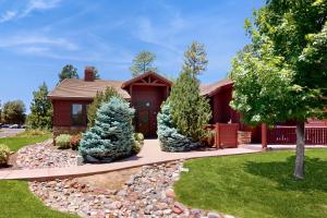 a house with a landscaped yard with a driveway at Torreon Tranquility in Show Low