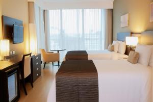 En eller flere senger på et rom på Tryp by Wyndham Panama Centro