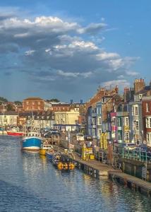 a group of boats are docked in a harbor at Great Georges Retreat Central Weymouth Beach Contactless Smart Accommodation in Weymouth