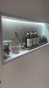 a shelf with four bottles of essential oils on it at شقق ميرال in Arar