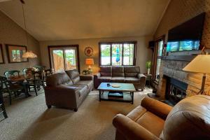 a living room with leather furniture and a fireplace at Big Boulder Lake Townhome in Lake Harmony