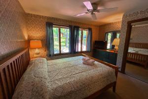 a bedroom with a bed and a ceiling fan at Big Boulder Lake Townhome in Lake Harmony +17 photos