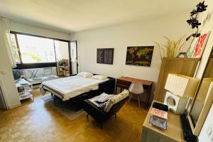 a room with a bed and a chair in it at Charming T2 with balcony near the Bastille in Paris