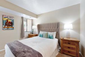 a bedroom with a large white bed and a window at New Claim Condominiums 114 in Park City