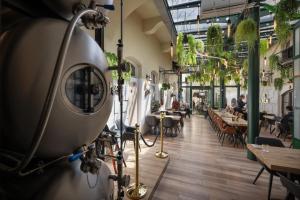 a camera in a restaurant with tables and chairs at Little King Hotel U Malvaze in Prague