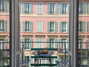 a balcony with a table and chairs and a building at Appartement Niçois - 3 Pièces au Centre in Nice