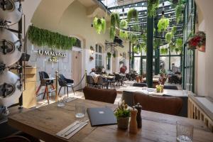 a restaurant with a table with a laptop on it at Little King Hotel U Malvaze in Prague