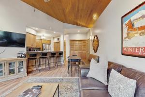 a living room and kitchen with a couch and a table at Deer Valley Courchevel Condo in Park City +13 photos