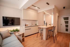 a kitchen and living room with a couch and a table at Luxury Apartments Stefano - Prestige in Ohrid
