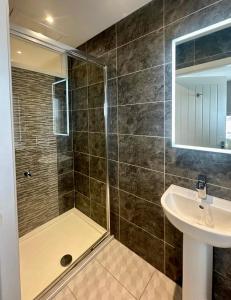 a bathroom with a shower and a sink at The Best Sea View Apartment in Lytham St Annes