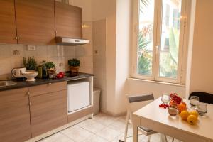 a kitchen with a table and a dining room at Book & Art Holiday House in Lido di Ostia
