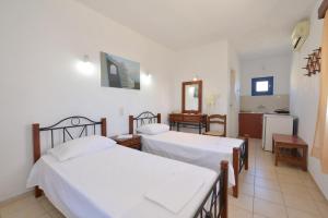 Postel nebo postele na pokoji v ubytování Windmill Villas