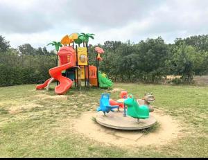 a park with a playground with a play equipment at Chalet Le Lagon in Cazilhac