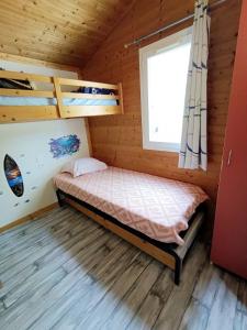 a bedroom with bunk beds in a wooden cabin at Chalet Le Lagon in Cazilhac +21 photos