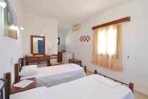 Postel nebo postele na pokoji v ubytování Windmill Villas