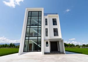 a white house with a large glass door at S island in Sanxing