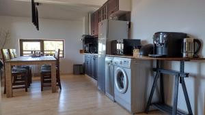 a kitchen with a washer and dryer next to a table at Pearl XL in Pamporovo