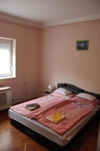 a bedroom with a bed with a plate of food on it at Hattyú vendégház Poroszló in Poroszló