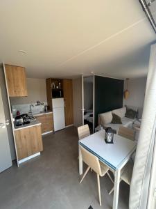 a kitchen and a living room with a table in a room at SPA et SAUNA de la presle in Saint-Georges-sur-Arnon