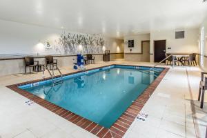 a pool in a hotel with chairs and tables at Sleep Inn & Suites Jasper I-22 in Jasper