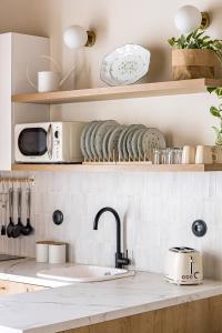 a kitchen counter with a sink and a microwave at La Casa del Caballero in Cartagena +21 photos