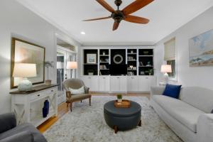 a living room with a couch and a ceiling fan at 219 Olive Way in East End