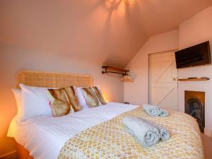 a bedroom with a bed with towels on it at 2 Bed in Evesham 88722 in Bretforton