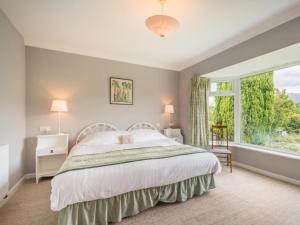 a bedroom with a bed and a large window at 3 Bed in Portinscale SZ528 in Portinscale