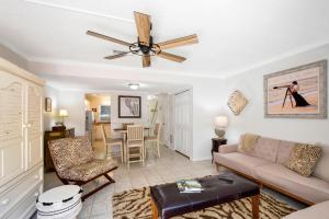 a living room with a couch and a ceiling fan at Kingstowne 425 #B in Golf Retreat