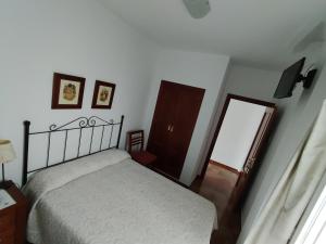 Postel nebo postele na pokoji v ubytování Hostal San Cayetano